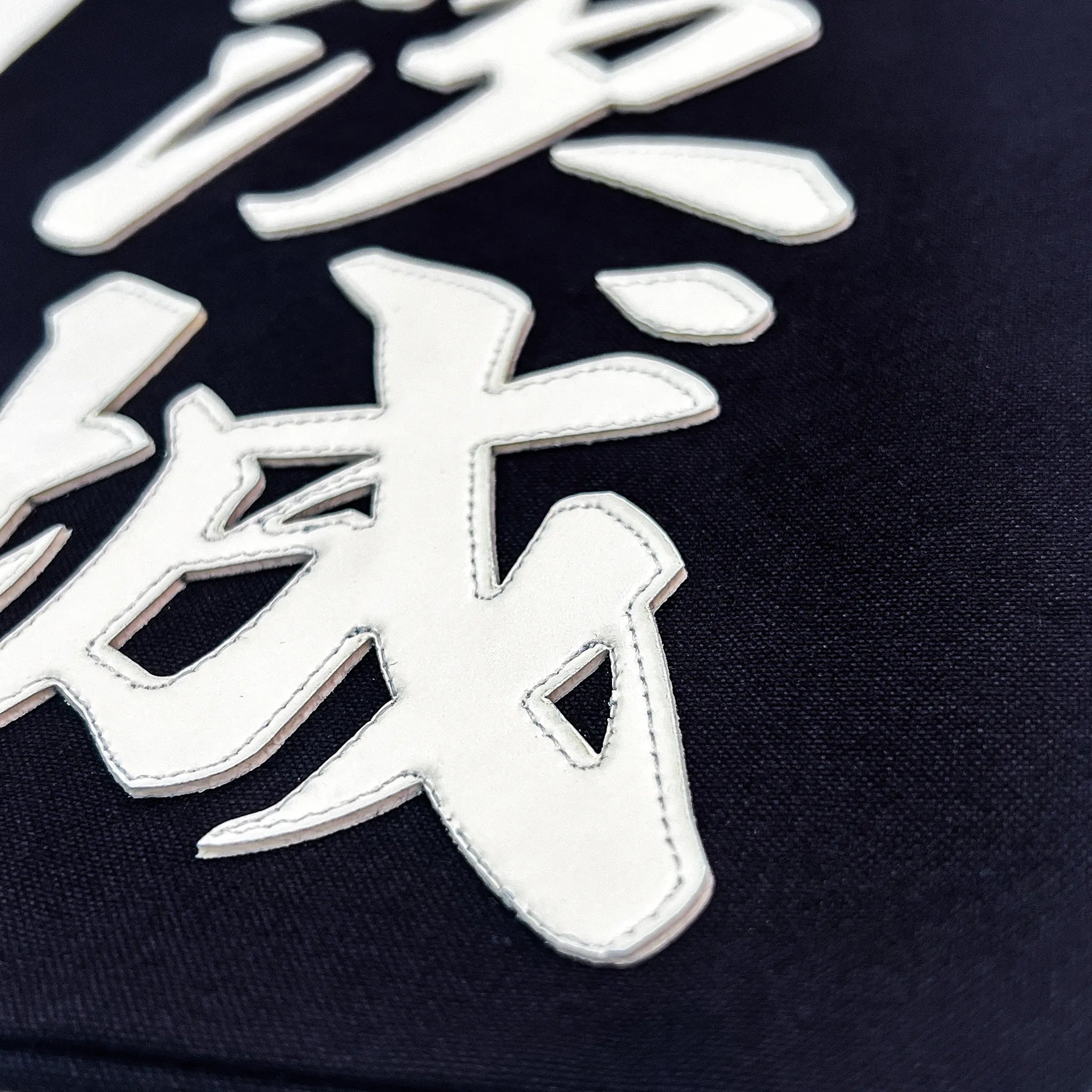 名札の文字のアップ写真。行書の特徴的なハネ